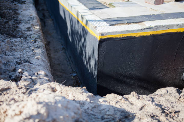 Professional Waterproofing technician working in Irvington, AL